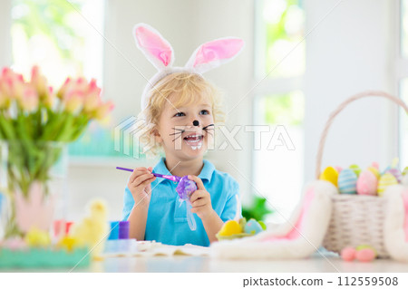 Kids on Easter egg hunt. Children dye eggs. Kids on Easter egg hunt. Children dye eggs. 112559508