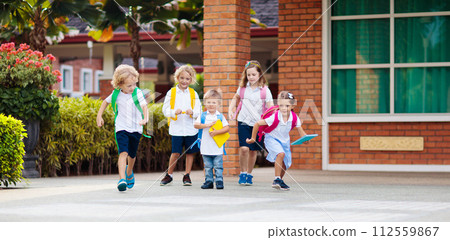 Child going back to school. Start of new school year after summer vacation. Little girl with backpack and books on first school day. Beginning of class. Education for kindergarten and preschool kids. 112559867