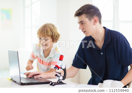 School kids with microscope. Science class. School kids with microscope. Science class. 112559940