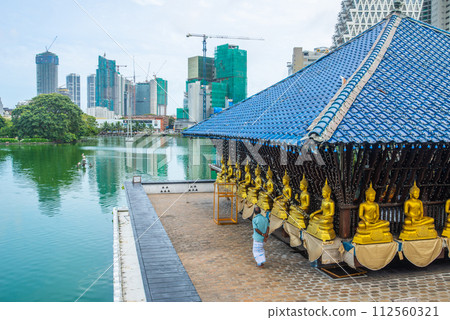 Sri Lankan people visiting Seema Malaka buddhist temple in the Beira Lake in Colombo, Sri Lanka. Seema Malaka temple is one of an iconic place in Colombo. 112560321