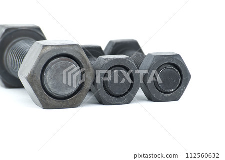Black metal bolts and nuts arranged on white background 112560632