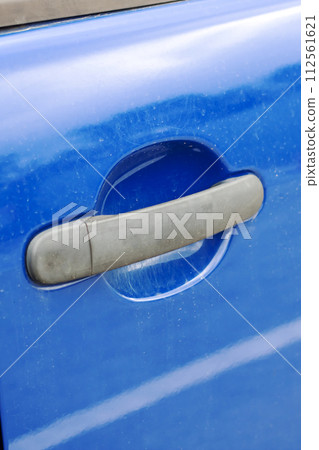 Door handle on a blue car closeup 112561621