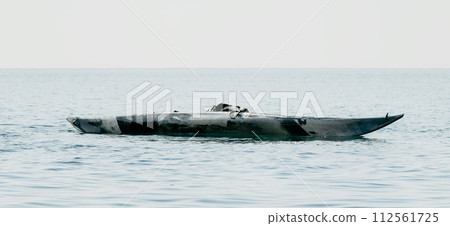Woman sea kayak. Happy smiling woman in kayak on ocean, paddling with wooden oar. Calm sea water and horizon in background. Active lifestyle at sea. Summer vacation. Woman sea kayak. Happy smiling woman in kayak on ocean, paddling with wooden oar. Calm sea water and horizon in background. Active lifestyle at sea. Summer vacation. 112561725
