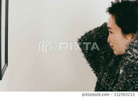 Stylish woman with a short cut setting her hair Stylish woman with a short cut setting her hair 112563213