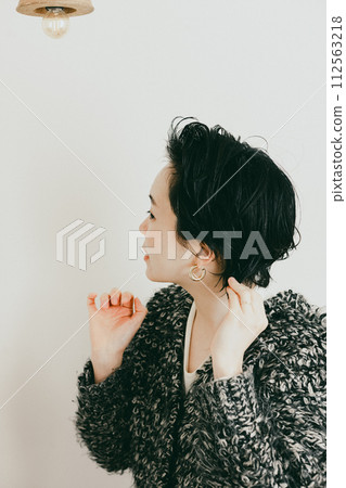 Stylish woman with a short cut setting her hair 112563218