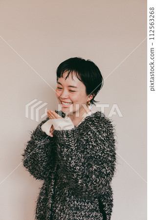 Portrait of a stylish short-cut woman with a cute smile and a white bag Portrait of a stylish short-cut woman with a cute smile and a white bag 112563268