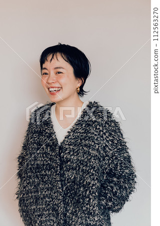 Portrait of a stylish short-cut woman with a cute smile and a white bag 112563270