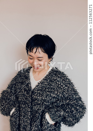 Portrait of a stylish short-cut woman with a cute smile and a white bag 112563271