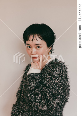 Portrait of a stylish short-cut woman with a cute smile and a white bag 112563272