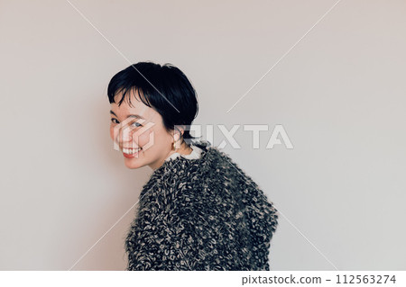 Portrait of a stylish short-cut woman with a cute smile and a white bag Portrait of a stylish short-cut woman with a cute smile and a white bag 112563274
