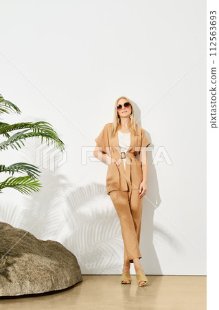 Portrait of relaxed woman in beige top and trousers 112563693