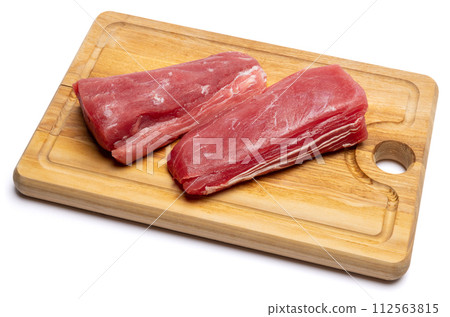 Fresh tuna Fish steak on a wooden cutting serving board isolated on a white background 112563815