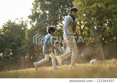 asian family enjoying outdoor activity in city park 112564207