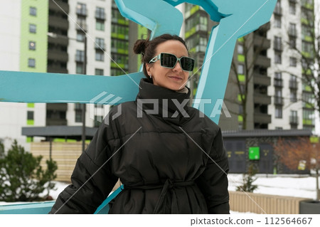 Weekend concept, brunette woman in a stylish black jacket walking in the cold Weekend concept, brunette woman in a stylish black jacket walking in the cold 112564667