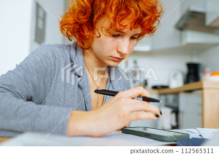 portrait attractive teenage girl filling out paper form portrait attractive teenage girl filling out paper form 112565311
