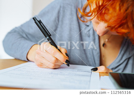 portrait attractive teenage girl filling out paper form portrait attractive teenage girl filling out paper form 112565316