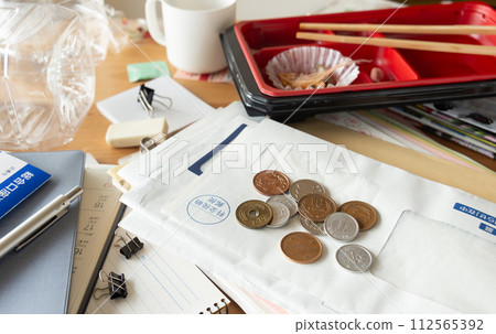 Desk cluttered with accumulated documents and mail, cluttered desk, scattered Desk cluttered with accumulated documents and mail, cluttered desk, scattered 112565392