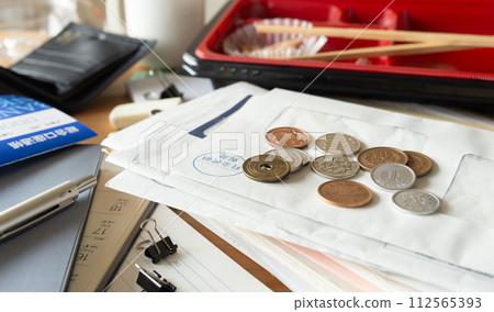 Desk cluttered with accumulated documents and mail, cluttered desk, scattered Desk cluttered with accumulated documents and mail, cluttered desk, scattered 112565393