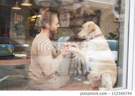 Pet friendly restaurants or public places, support dog, pets as companions. Outdoor shot of cafe window where a visit with golden retriever enjoying quality time Pet friendly restaurants or public places, support dog, pets as companions. Outdoor shot of cafe window where a visit with golden retriever enjoying quality time 112566744