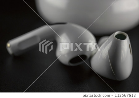 ROSTOV-ON-DON, RUSSIA - APRIL 28, 2018: Apple AirPods wireless Bluetooth headphones and charging case for Apple iPhone. New Apple Earpods Airpods in box. ROSTOV-ON-DON, RUSSIA - APRIL 28, 2018: Apple AirPods wireless Bluetooth headphones and charging case for Apple iPhone. New Apple Earpods Airpods in box. 112567618