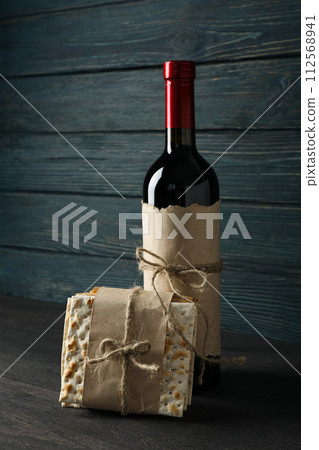 Matzo and bottle of wine on wooden background Matzo and bottle of wine on wooden background 112568941
