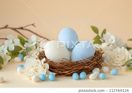Painted blue Easter eggs in a nest among white flowers in the morning spring sun, pastel beige background, Happy Easter day concept  and idea, copy space 112569126