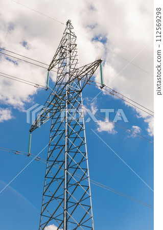 A power line mast against the sky and clouds. View from below A power line mast against the sky and clouds. View from below 112569298