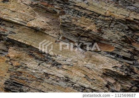 Rough rocky mountain texture. Sedimentary rock texture Rough rocky mountain texture. Sedimentary rock texture 112569687