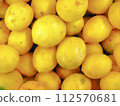 A photo of a stack of Lemons (Citrus limon) captured from a top-down perspective. Ideal for use as a background image or illustrative photo for articles related to food and health themes. 112570681