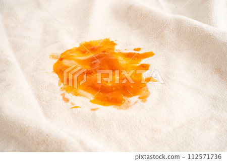 Dirty tomato sauce stain or ketchup on cloth to wash with washing powder, cleaning housework. Dirty tomato sauce stain or ketchup on cloth to wash with washing powder, cleaning housework. 112571736
