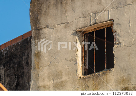 House window with iron bars resembles prison cell from street, from where every day there is less and less hope for release, review criminal case, acquittal and release. Innocently convicted concept House window with iron bars resembles prison cell from street, from where every day there is less and less hope for release, review criminal case, acquittal and release. Innocently convicted concept 112573052
