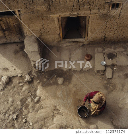 AI-generated content. An aerial view capturing an old woman carrying a bucket as she moves near her hut. 112573174