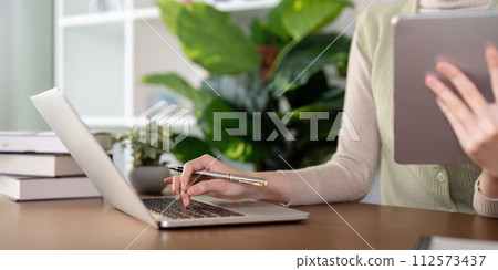 Woman creative in home office and laptop for research in remote work, social media or blog in home office. Freelance at desk with computer writing email, website post and online chat in house 112573437