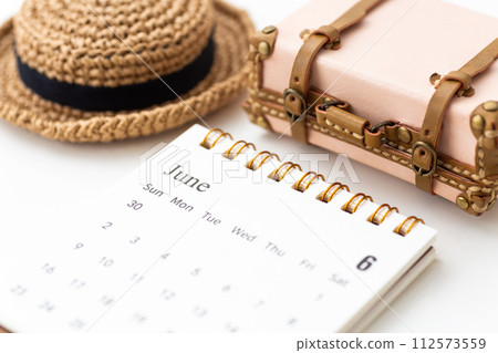 June calendar with straw hat and trunk June calendar with straw hat and trunk 112573559