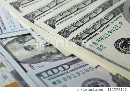 One hundred dollar bills folded in a fan. A lot of dollars One hundred dollar bills folded in a fan. A lot of dollars 112574112