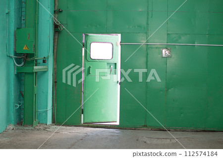 Green iron wall with half-open door Green iron wall with half-open door 112574184