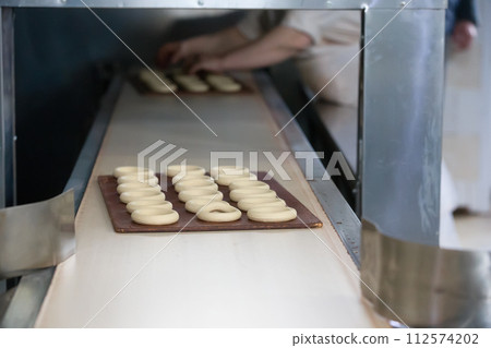 Industrial line for the production of biscuits and bagels. Conveyor belt for the production of culinary products Industrial line for the production of biscuits and bagels. Conveyor belt for the production of culinary products 112574202