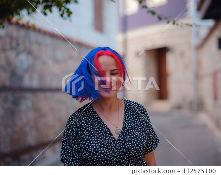 female summer old town walk in Antalya Turkey. woman with colorful hair and dress gracefully explores its historic streets. creating visual symphony that harmonizes past and present. female summer old town walk in Antalya Turkey. woman with colorful hair and dress gracefully explores its historic streets. creating visual symphony that harmonizes past and present. 112575100