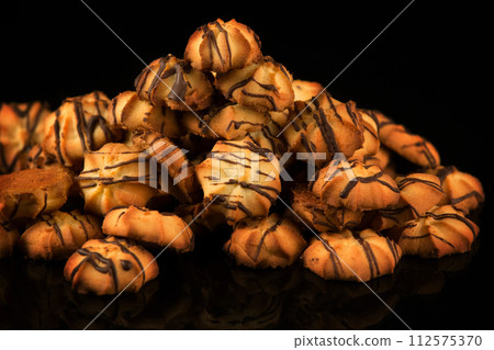 Shortbread cookie with chocolate icing on a dark background Shortbread cookie with chocolate icing on a dark background 112575370
