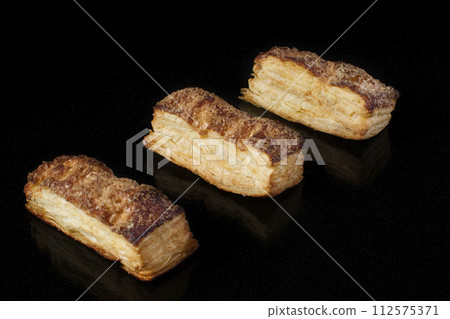 Puff pastry cookies on a black background Puff pastry cookies on a black background 112575371