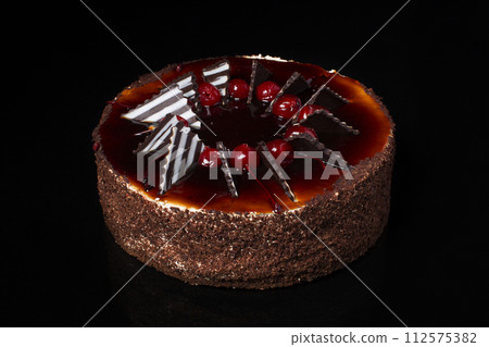 Chocolate cake on a black background Chocolate cake on a black background 112575382