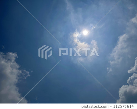 Heavenly white clouds on the blue sky with the sun appeared 112575614