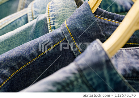 Blue denim jackets on a hangers Blue denim jackets on a hangers 112576170