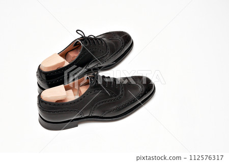 Beautifully polished black full brogue British leather shoes Beautifully polished black full brogue British leather shoes 112576317