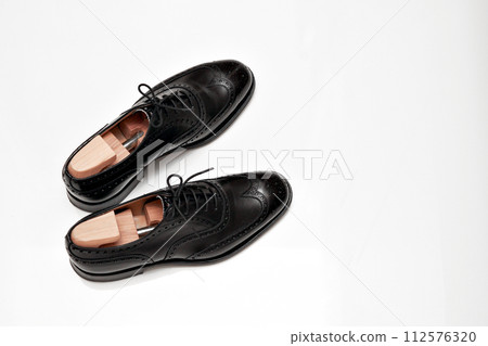 Beautifully polished black full brogue British leather shoes Beautifully polished black full brogue British leather shoes 112576320