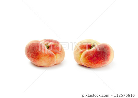 Two saturn peaches or flat peaches isolated on white background with clipping path.. 112576616