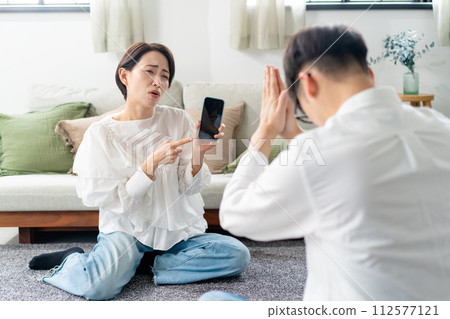 A woman angry with a smartphone A woman angry with a smartphone 112577121