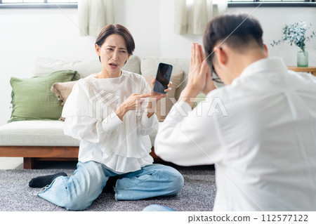 A woman angry with a smartphone A woman angry with a smartphone 112577122