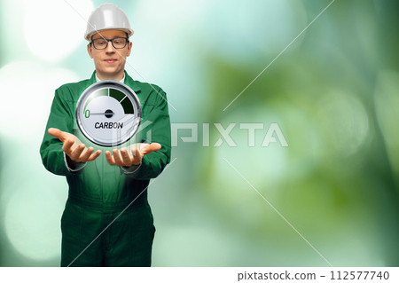 Engineer is holding a gauge with inscription CARBON. Arrow points to zero. 112577740