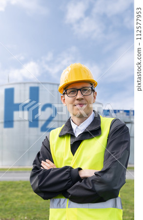 Engineer in helmet on a background of Hydrogen factory Engineer in helmet on a background of Hydrogen factory 112577953